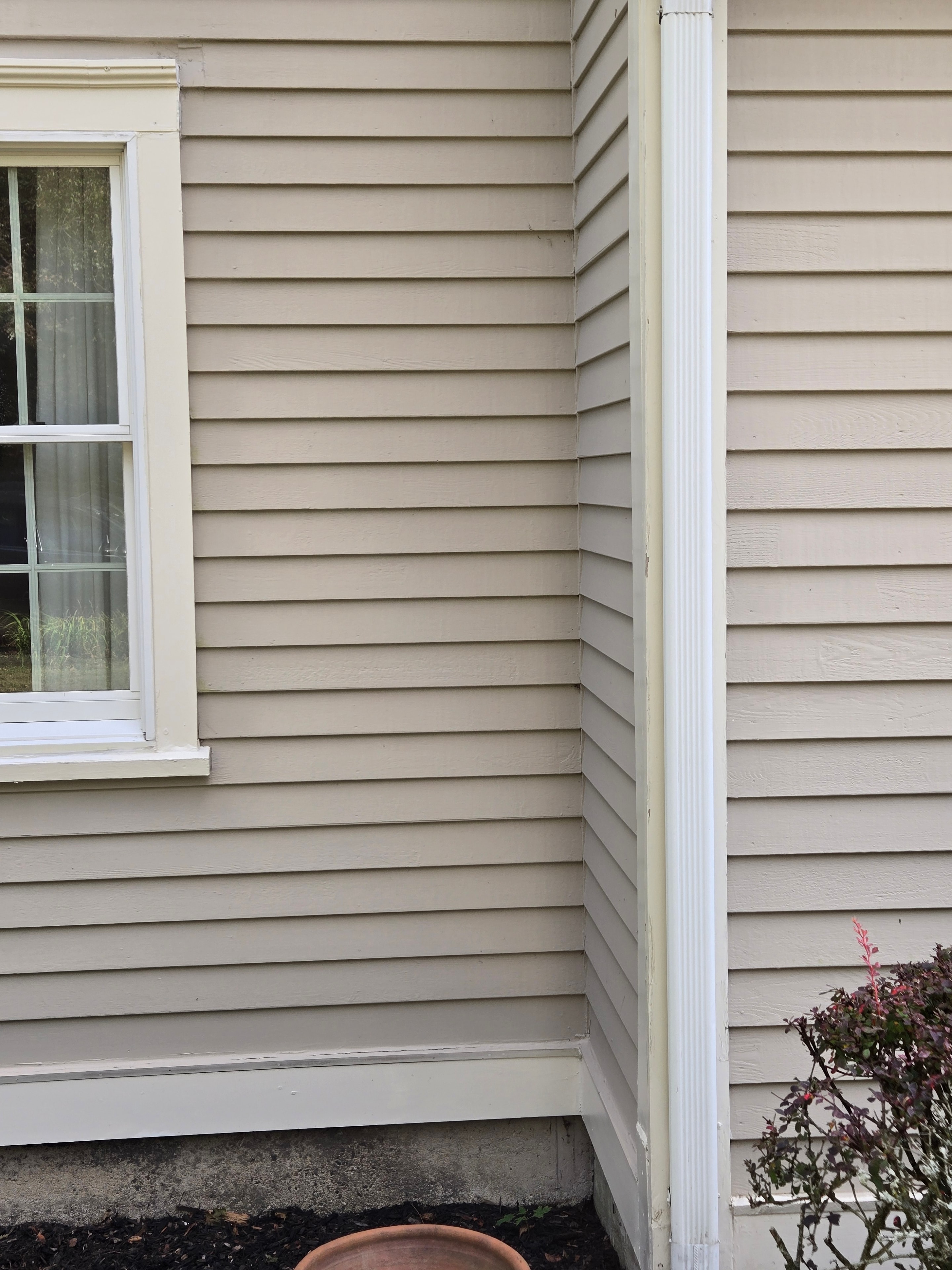 After: freshly painted white gutter